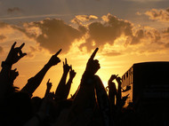 Hands at a concert being thrown into the air.