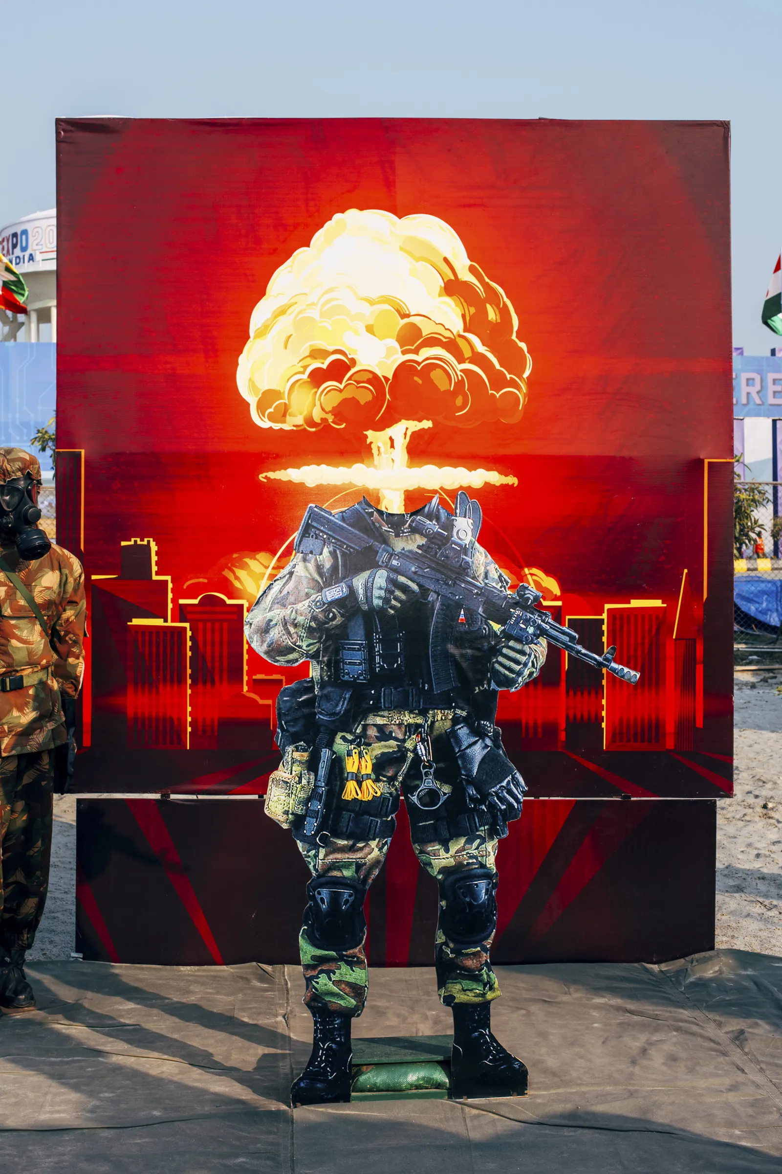Zu sehen ist eine Fotografie von Nikita Teryoshin: Eine in Soldatenkleidung eingekleidete Puppe steht vor einem Bild mit einer Atomexplosion drauf.