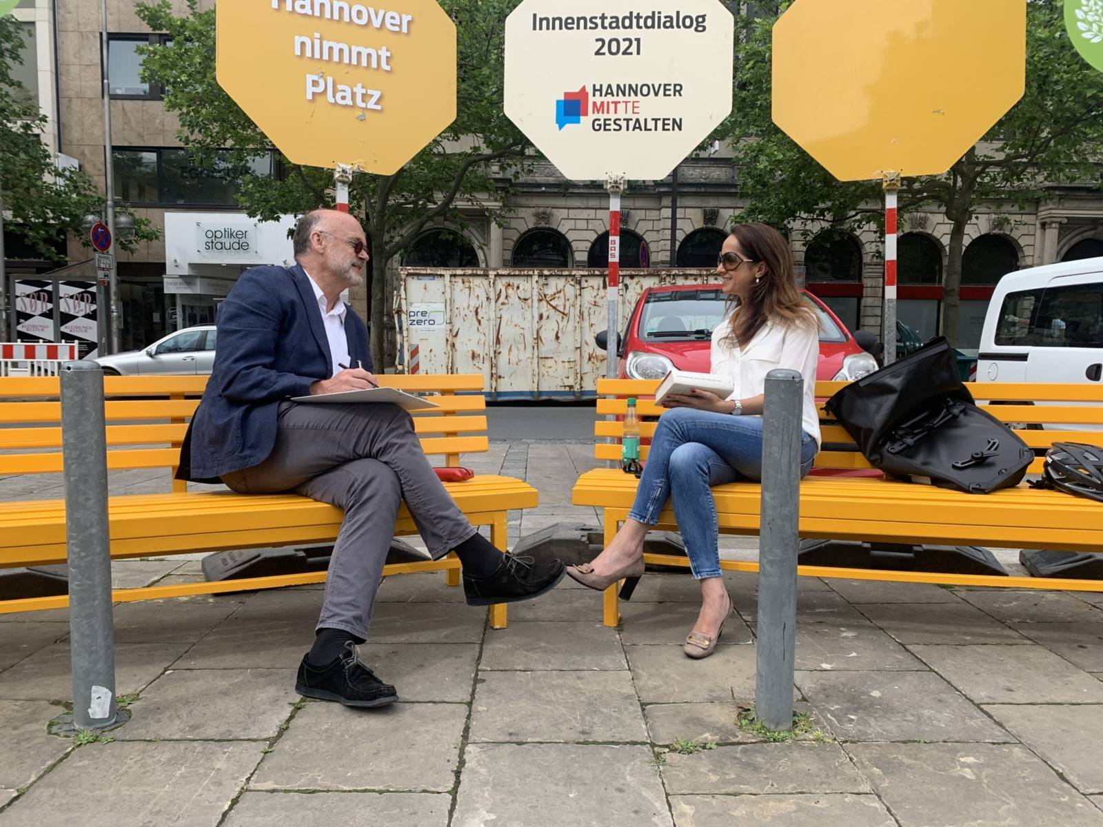 Zwei Personen im Gespräch auf einer Bank in Hannovers Innenstadt.