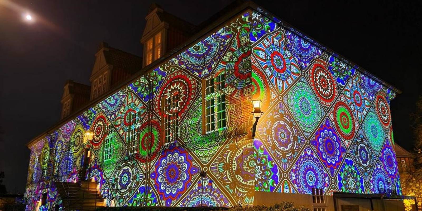 Die Fassade von Schloss Landestrost wird farbig und mit Mustern angeleuchtet.