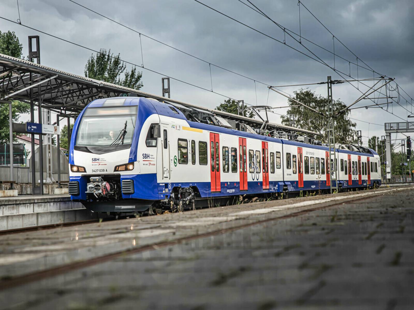 Eine blau-weiße S-Bahn steht an einem Bahnsteig.