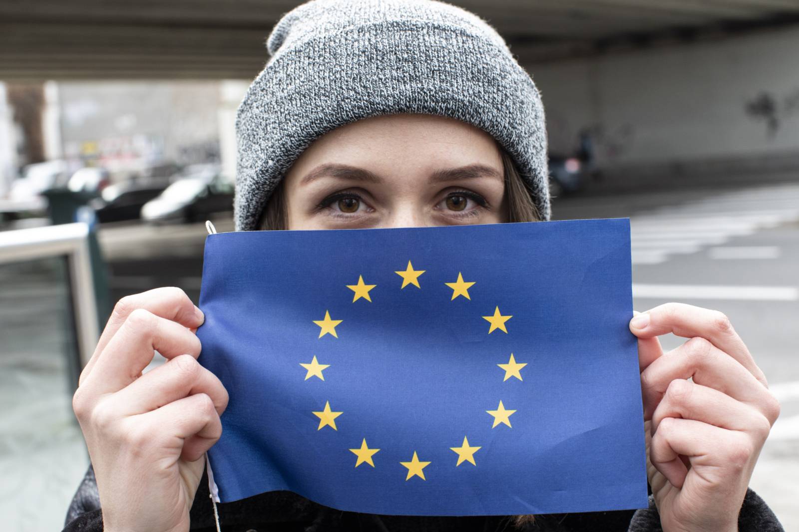 A person holding an EU flag