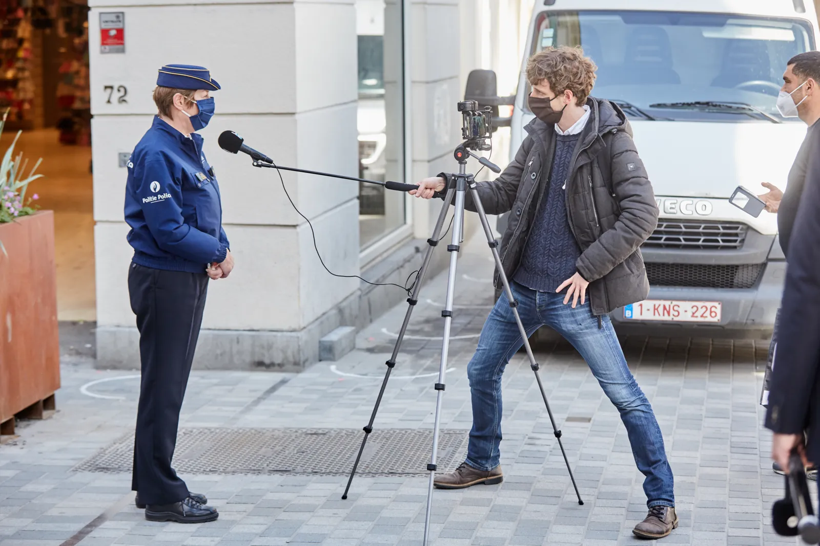 A police officer being interviewed by a journalist