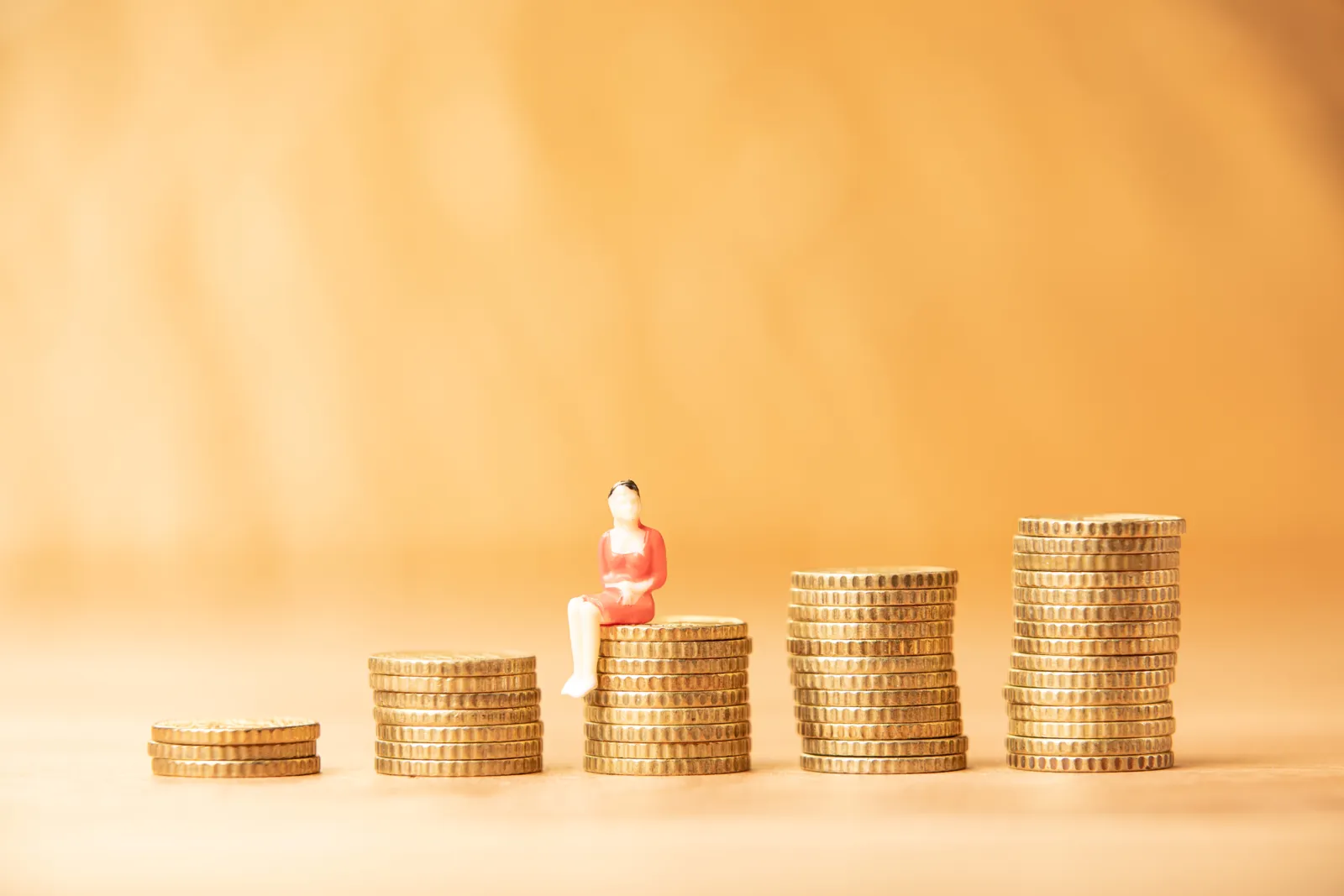 Coins and miniature figurine