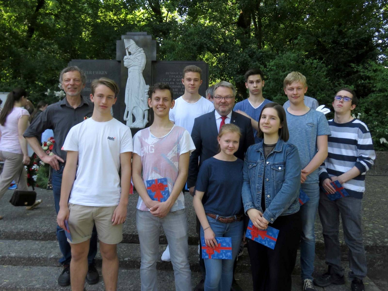 Bürgermeister Thomas Hermann mit Schülerinnen und Schülern der St.-Ursula-Schule am Ehrenfriedhof Maschsee-Nordufer