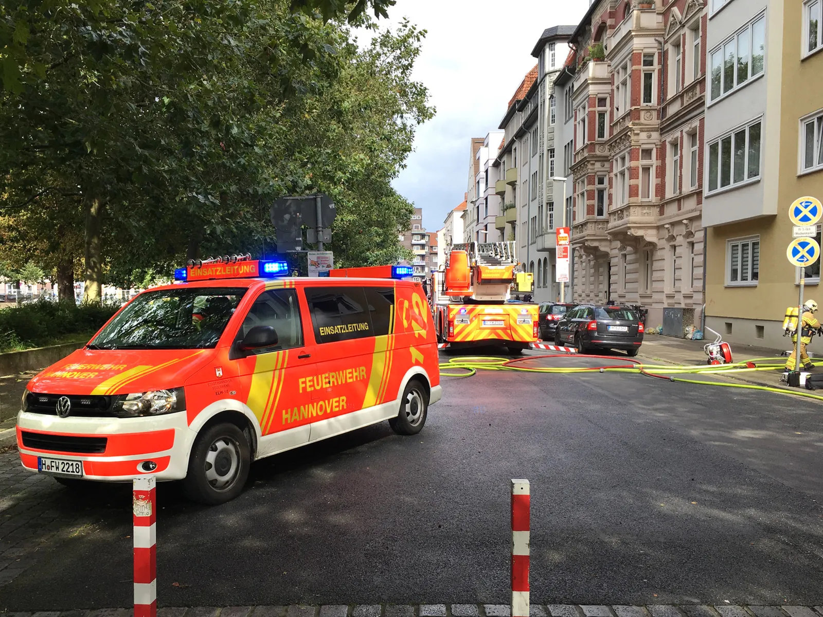 Einsatzleitwagen und Drehleiter der Feuerwehr Hannover, vor der betroffenen Wohnung.