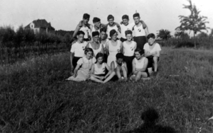 Boys and girls in sports clothing, 1936. The girls’ building is in the background. From the photo album of Ilse Buchholz (later Deborah Bakschitzky), who is sitting in the front row on the right.