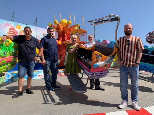 Fünf Personen auf einem Fahrgeschäft.