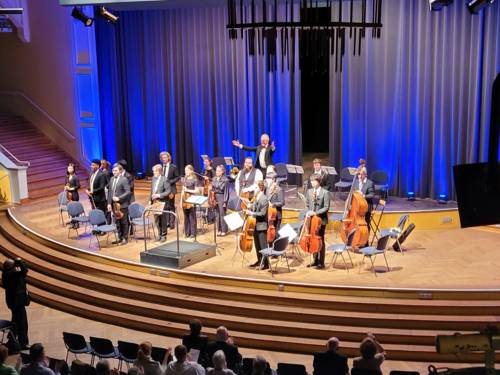 Blick von oben auf ein Orchester, das auf einer Bühne spielt