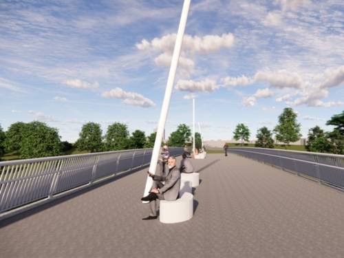 Auf einer breiten Br&uuml;cke mit Fu&szlig;weg sind in der Mitte zwei wei&szlig;e Sitzelemente, darauf sitzt ein Mann im Anzug.