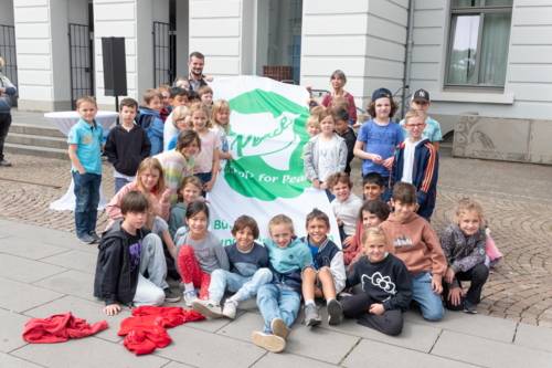 Bürgermeister Karsten Ludwig, Stadt Krefeld, zusammen mit einer Schulklasse und der Flagge der Mayors for Peace