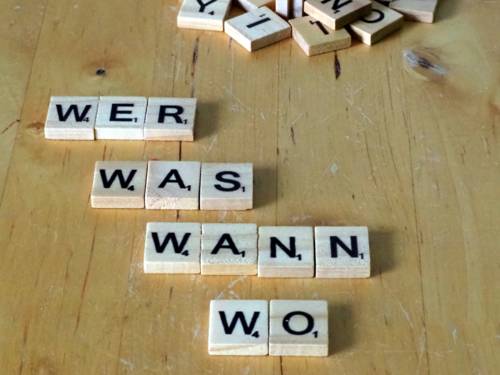 Buchstabenplättchen bilden die W-Fragen Wer, was wann und wo.