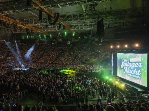 Blick in eine Konzerthalle, die voller Menschen ist.