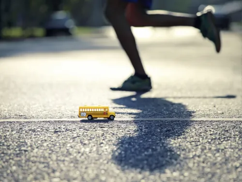 Ein gelber Miniatur-Bus der auf Asphalt steht.