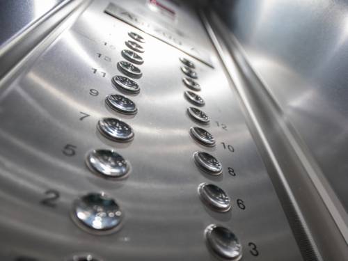 Zahlen stehen neben runden Knöpfen. Darüber lassen sich die Stockwerke wählen, die der Aufzug anfahren soll.