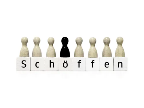 Weiße Mensch-Ärger-Dich-Nicht-Spielfiguren symbolisieren die Jugenschöffinnen und -schöffen, die schwarze Figur steht für die Richterin bzw. den Richter