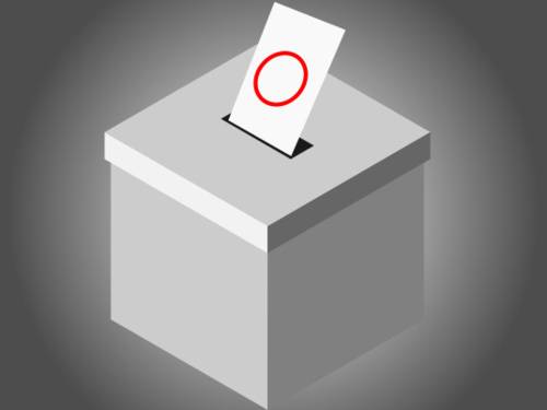 Abbildung einer Wahlurne, in dessen Schlitz ein Zettel steckt.