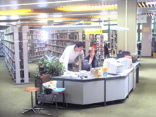 Informationstresen mit einem Mitarbeiter und einer Mitarbeiterin in der Stadt- und Schulbibliothek Bothfeld