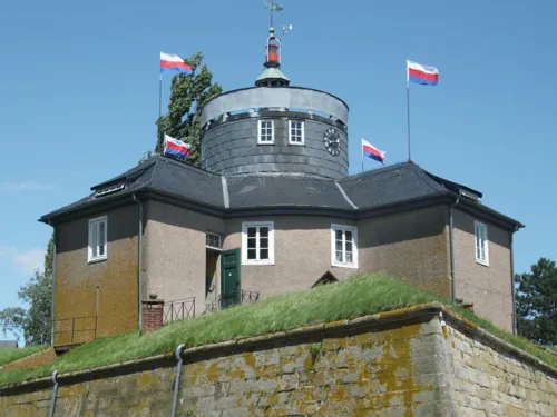 Gebäude auf einer mit Mauern befestigten Rasenfläche