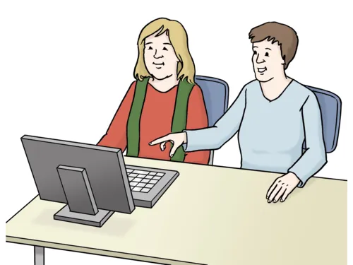 Eine Person erklärt etwas am Computer.