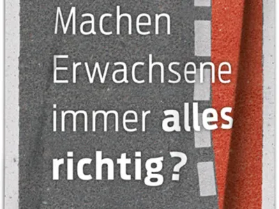 Das Plakat mit der Aufschrift "Machen Erwachsene immer alles richtig?" macht darauf aufmerksam, die Fehler von anderen Verkehrsteilnehmern zu berücksichtigen.