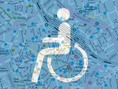 Piktogramm eines Rollstuhlfahrers vor Stadtkarte
