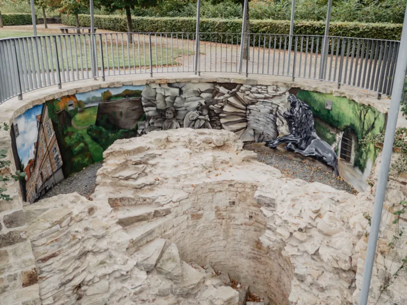 Blick auf ein Graffitto auf einer halbrunden Mauer