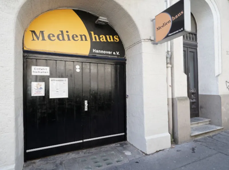 Haus mit breitem Toreingang, dar&uuml;ber ein Schild Medienhaus e.V. Hannover 