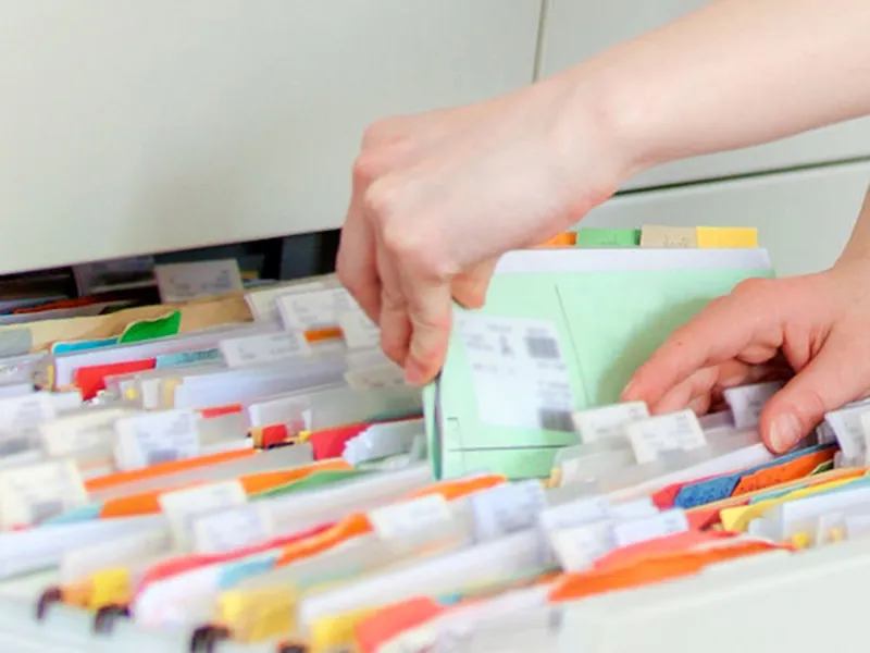 H&auml;nde auf Akten in einem Register