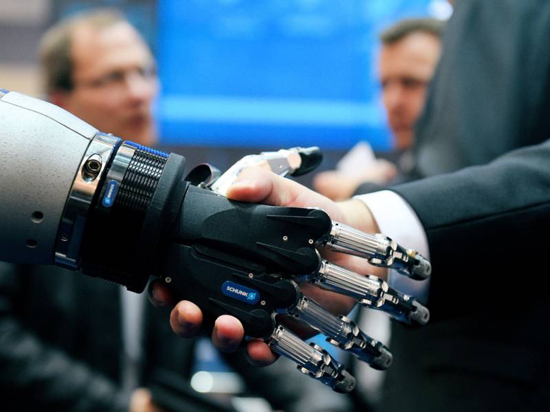 Handschlag zwischen einer menschlichen und einer Roboterhand.