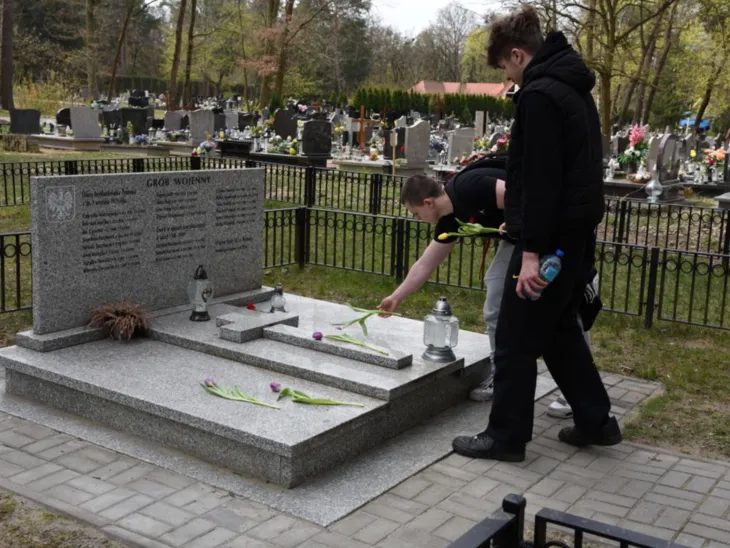 Jugendliche aus der Region Hannover und dem Landkreis Posen legen Blumen auf ein Grab am Friedhof Miłostowo in Polen.