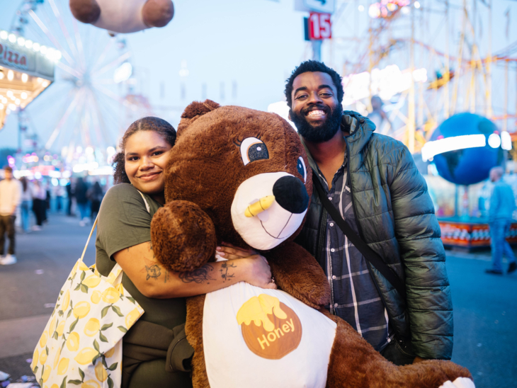 Ein Erwachsener und ein Kind mit einem großen Teddy.