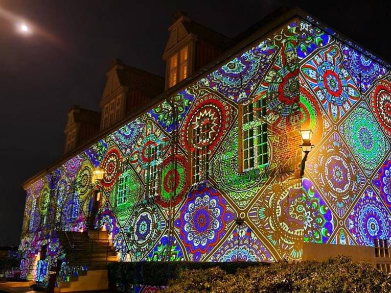 Die Fassade von Schloss Landestrost wird farbig und mit Mustern angeleuchtet.