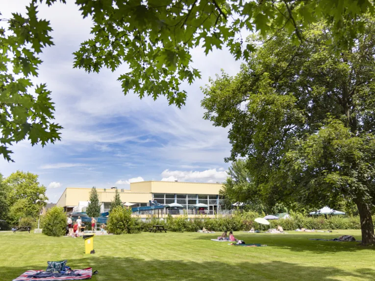 Rasenfläche und Schwimmhalle