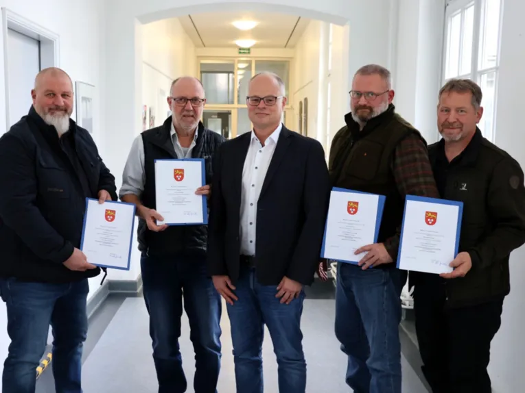 Fünf Männer, vier mit Urkunden