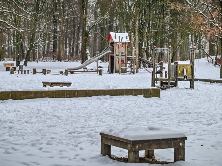Mit Schnee bedeckter Spielplatz im Stadtwald Eilenried