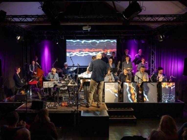 Zu sehen ist das Orchester Fette Huppe auf deer Bühne