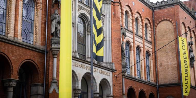 Das Künstlerhaus Hannover von außen. Davor schwarz-gelbe Flaggen.