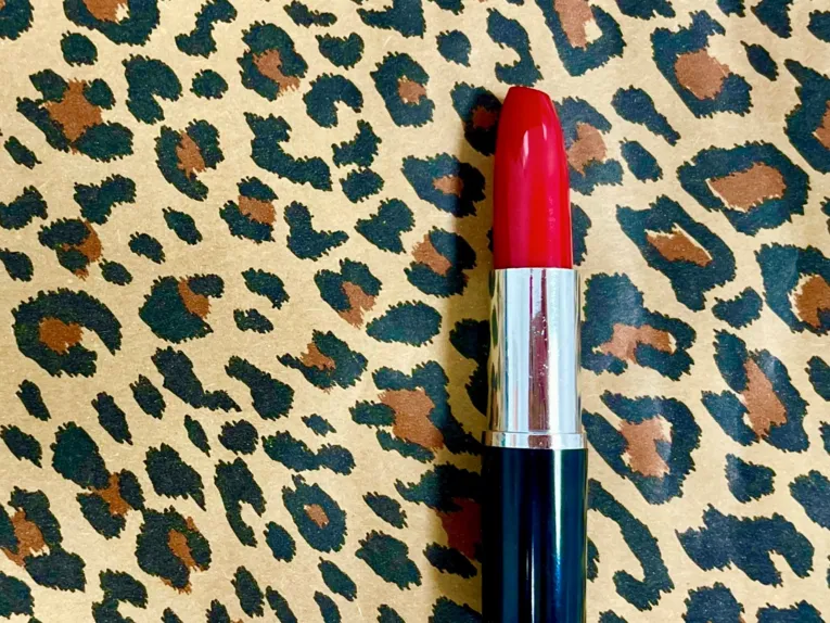 Roter Lippenstift auf einem Stück Stoff mit Tigermuster