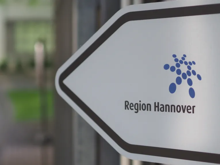 Regionslogo auf einem Wegweiser