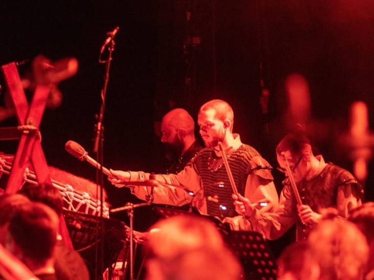 Zu sehen sind Trommler auf der Bühne in mittelalterlich angehauchten Kostümen.