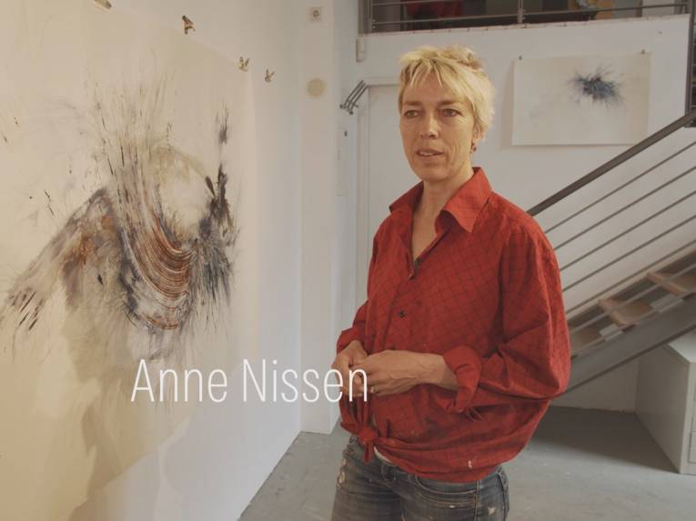 Bild aus einem Videoclip: Eine Künstlerin empfängt in ihrem Atelier