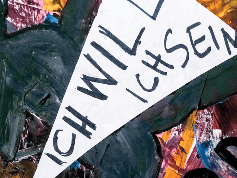 Zu sehen ist eine abstrakte Malerei, davor der Satz: Ich will ich sein