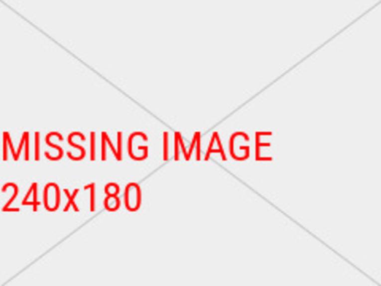 Im Vordergrund Menschen auf einer Badeplattform im Blauen See und ein blaues Schlauchboot, im Hintergrund eine Wasserrutsche, Badegäste und Birken