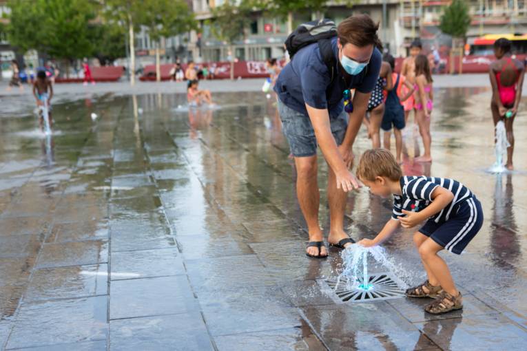 A child playing in water jets 