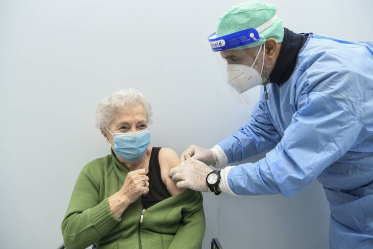 A military doctor administering influenza vaccine to a patient