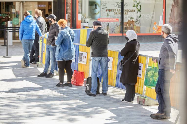 People lining up in front of stores