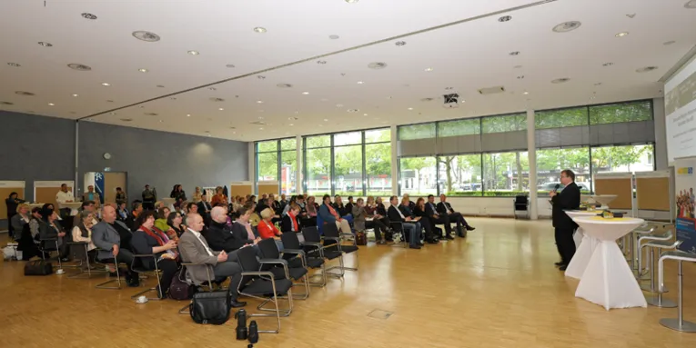Vortragsraum im Haus der Region, links die Teilnehmer, rechts ein Redner