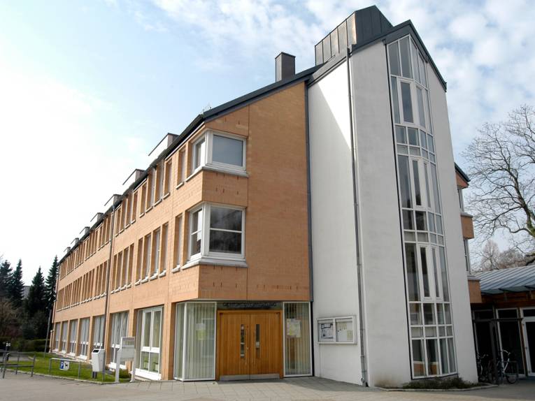 Moderner, dreigeschossiger Verwaltungsbau. Über dem Haupteingang steht "Gemeindeverwaltung", daneben hängt ein Glaskasten für Aushänge.