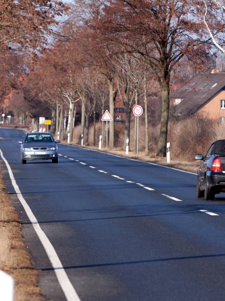 Kreisstraße mit zwei Autos (Hochformat) Bauarbeiten, Straßen, Verkehr